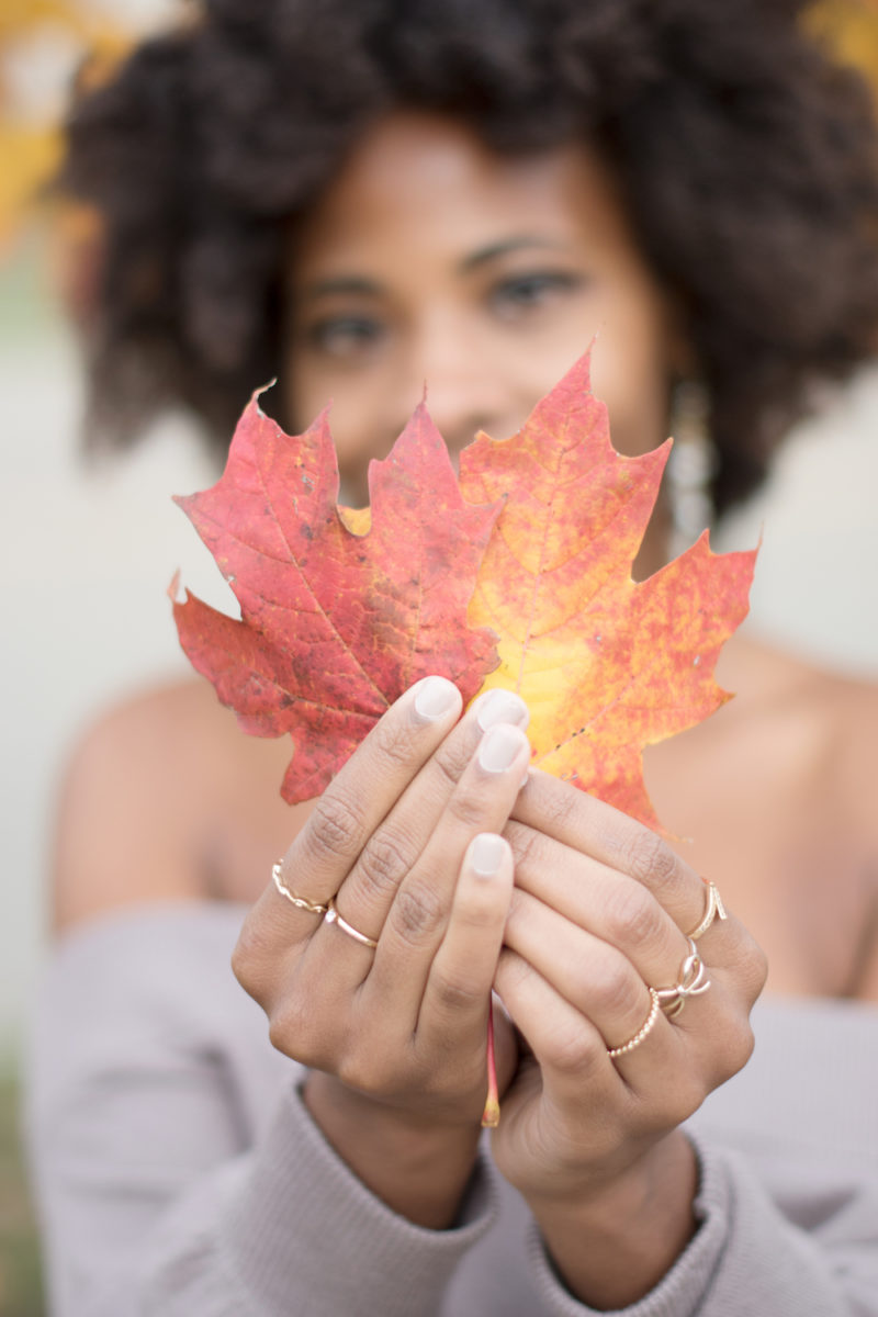 holding red fall leaves